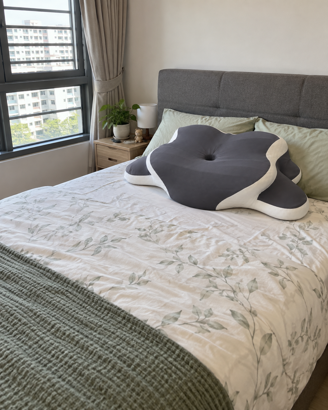 Big Ear Pillow arranged on a bed beside a bright bedroom window